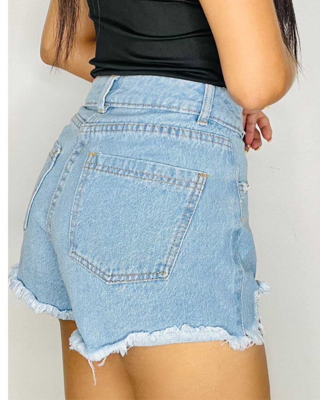 Shorts de jeans tiro alto color azul claro con detalles rotos y desflecados. Corte ajustado. Tallas 6 a 14. Jessi Boutique
