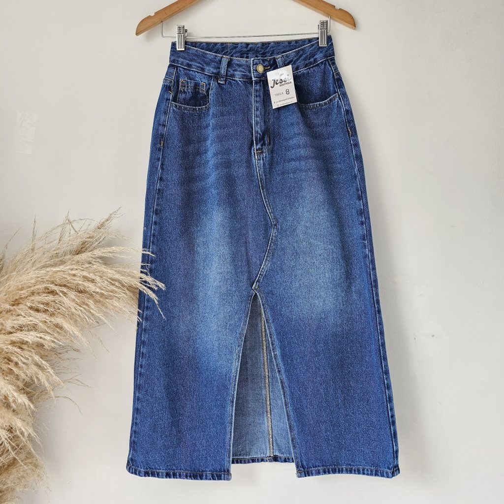 Falda larga de mezclilla para mujer con abertura frontal y bolsillos. Falda denim midi en tono azul oscuro prelavado. Jean rígido de tiro alto. Moda femenina Jessi Boutique.