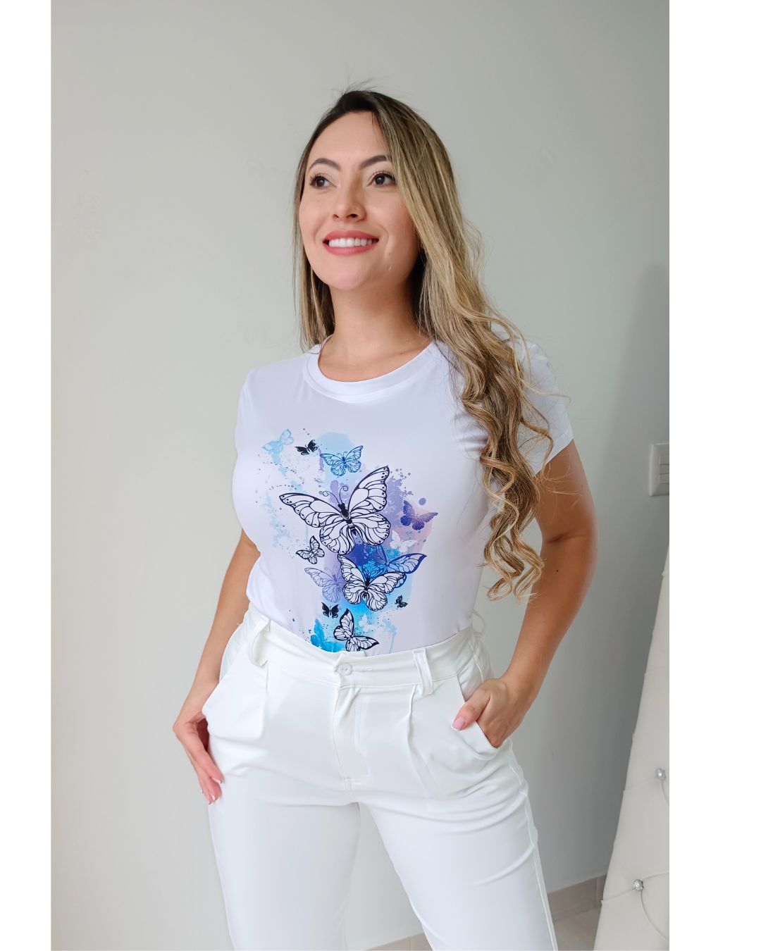 Camiseta blanca para mujer en tela piel de durazno con estampados sublimados de mariposas, flores y moda. Camiseta de cuello redondo y manga corta. Talla única. Jessi Boutique.